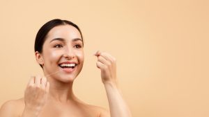 woman flossing her teeth